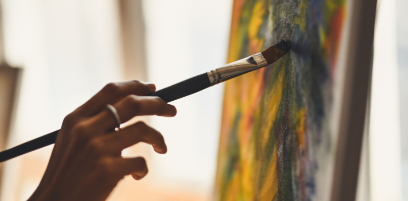 An artist painting on a canvas