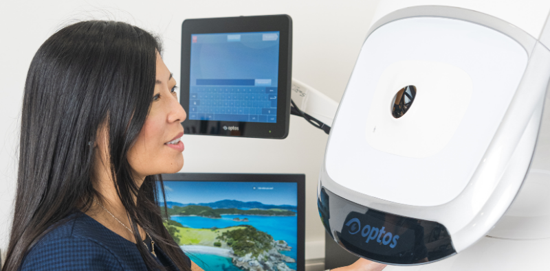 An optometrist at Mirage Opticians in Ealing using advanced eye exam equipment