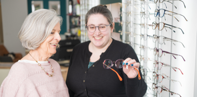 Two women discussing eyewear choices at Mirage Opticians